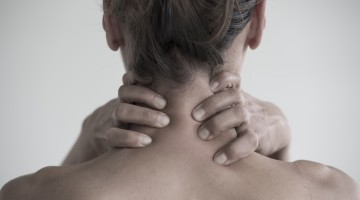 Closeup shot of a female having a neck pain